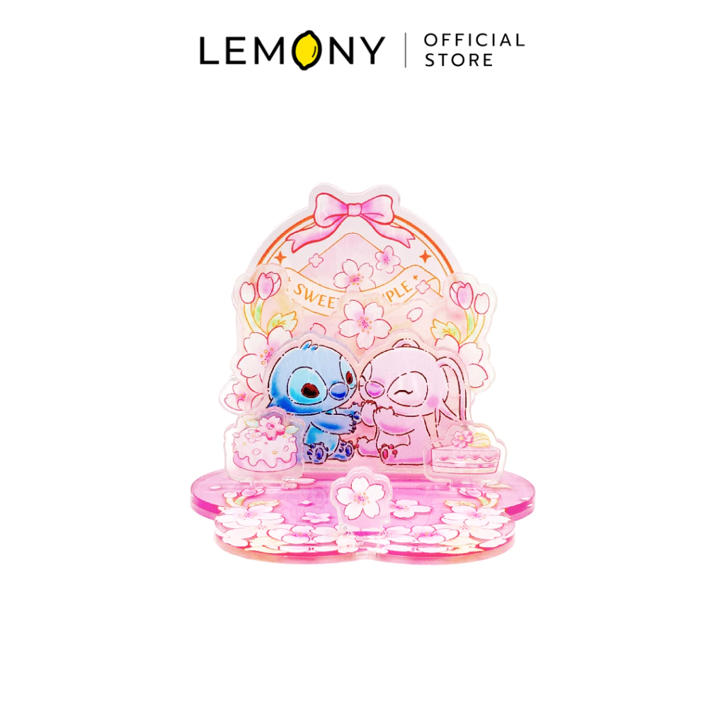 LEMONY แท่นวางโทรศัพท์มือถืออะคริลิก ลายสติทช์และแองเจิล (Stitch & Angel) ประกอบเสร็จสมบูรณ์ในธีมซากุระสีชมพูหวานละมุน โดดเด่นด้วยตัวการ์ตูนนูนสามมิตินั่งคู่กันหน้ากรอบรูปจดหมายคู่รัก แผ่นฐานฉลุลายกลีบดอกไม้พร้อมช่องสำหรับตั้งวางสมาร์ทโฟน