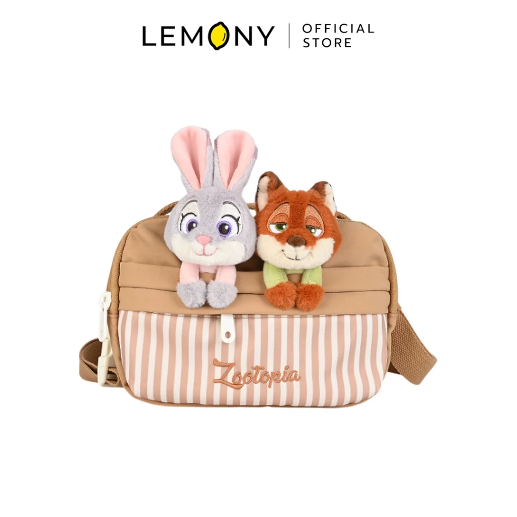 LEMONY กระเป๋าคาดอกดิสนีย์ ลาย Zootopia ทรงกล่องสี่เหลี่ยมผืนผ้าโทนสีน้ำตาลชานมสลับลายทางแนวตั้งสีขาว มีช่องซิปด้านหน้าปักอักษรชื่อเรื่อง โดดเด่นด้วยตุ๊กตาหัวนูนสามมิติดีไซน์คู่หูนักสืบกระต่ายจูดี้และจิ้งจอกนิคเกาะอยู่บนขอบกระเป๋า